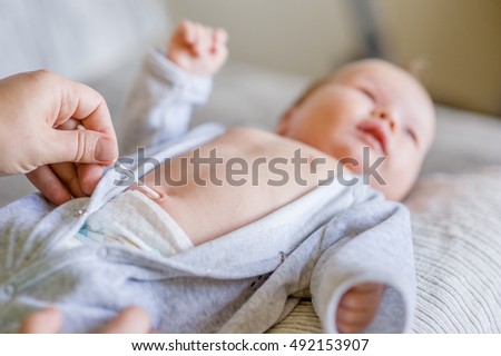 Treatment of newborn baby navel with a cotton swab Royalty-Free Stock Photo #492153907