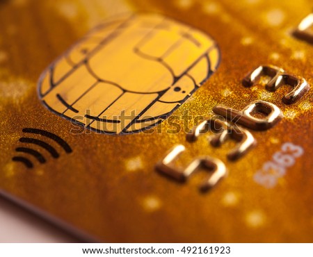 Stack of bank cards. Credit cards. Close-up picture of a credit cards as a background. Macro shot , Selective focus. A microchip and raised numbers on a bank card