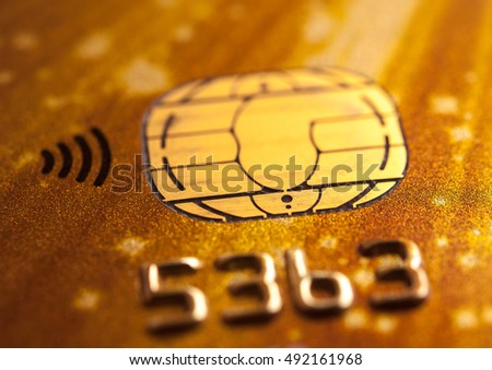 Stack of bank cards. Credit cards. Close-up picture of a credit cards as a background. Macro shot , Selective focus. A microchip and raised numbers on a bank card
