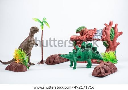 T-rex  and Stegosaurus dinosaur toy model on Earth millions of years white background