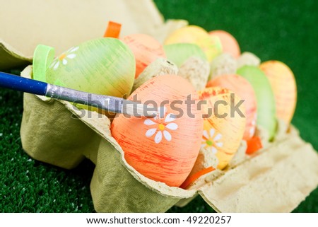 easter eggs in cartoon box and one brush