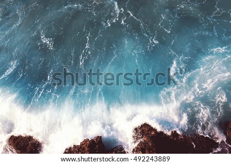 Sea landscape background, water with waves and rock, soft colors dramatic photo