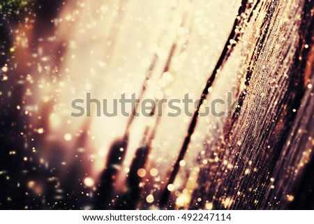 Christmas background with falling snow and Xmas lights on dark wooden board - Xmas Card with copy space for greeting text. 