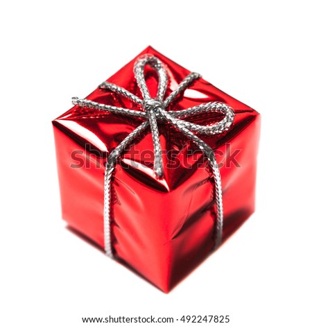 Red gift box with ribbon bow isolated on white background close up