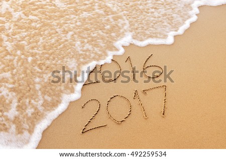 New Year 2017 replace 2016 on sea beach summer, New Year 2017 is coming concept. Closeup. Royalty-Free Stock Photo #492259534