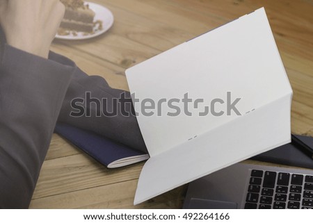 Woman with coffee cup and laptop on the wooden table