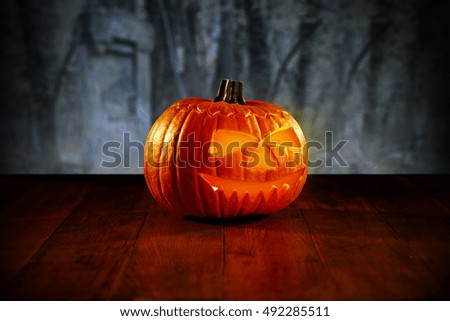 pumpkin of orange color on wooden desk and halloween time 
