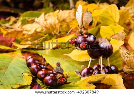 cute brown chestnut animals among yellow green autumn leaves