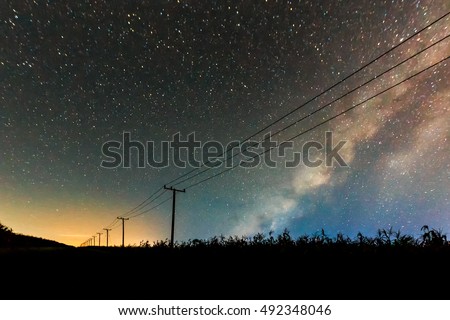 long exposure photography of abstract night sky with stars and milky way over the power line