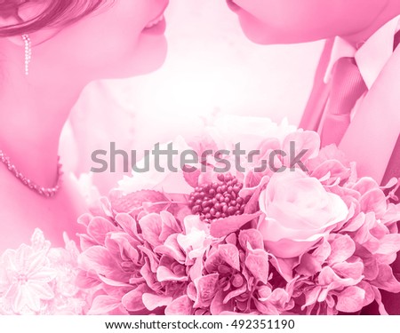 Bride and groom are holding a bridal bouqu