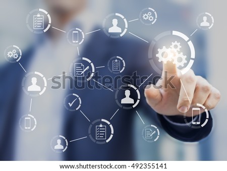 Robotic process automation of business workflows with a businessman in background touching a button Royalty-Free Stock Photo #492355141