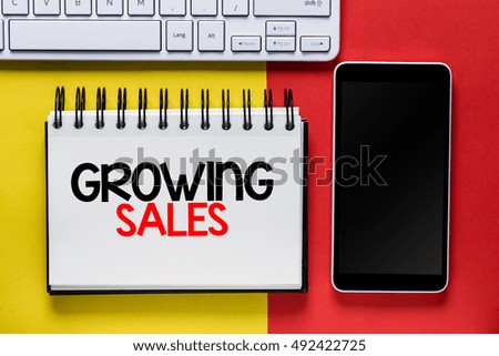 Growing sales./ The word growing sales notebook computer and smartphone.
