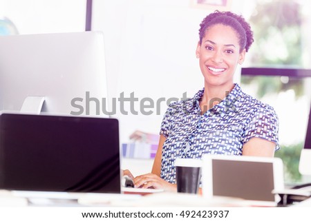 Portrait of smiling afro-american office worker in offfice