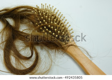 Women losing hair on brushhair.selective focus or blurry