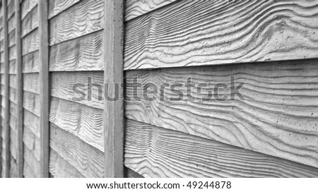 Gray faux wood fence dimishing in perspective