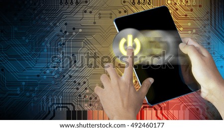 Hand press power button on a digital tablet screen with abstract technology background