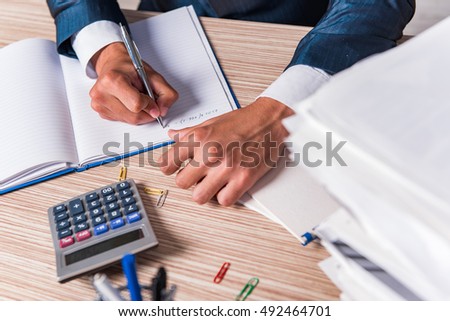 Businessman writing report in the office