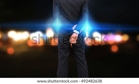 Businessman standing looking to the city.