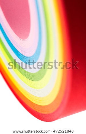 curled in a roll, twisted colored paper ribbon like a rainbow, in macro lens shot small-DOF for screen wallpapers