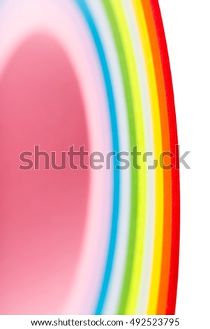 curled in a roll, twisted colored paper ribbon like a rainbow, in macro lens shot small-DOF for screen wallpapers