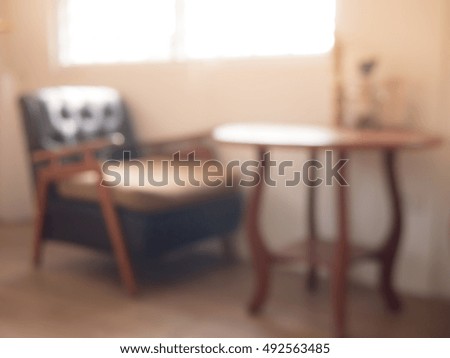 Details of an interior of a small cafe. Just chairs, empty frames and tables, image blur.