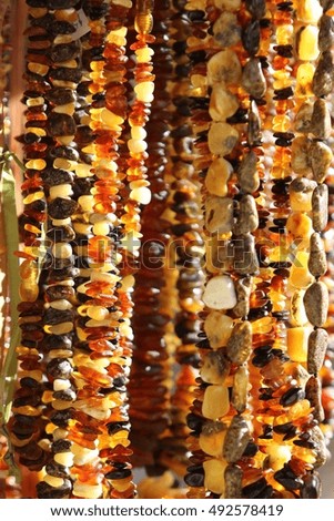 Many different amber beads, necklace. Daylight, space and outdoor , original photo
