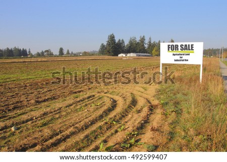A sign advertises agricultural land for industrial use for sale/Agricultural Land for Industrial Use/A sign advertises agricultural land for industrial use for sale. 