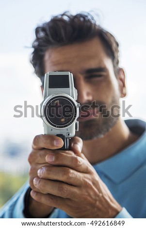Handsome young man with old fashioned camera