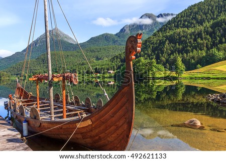Old viking boats replica in a norwegian landscape, Norway. Royalty-Free Stock Photo #492621133