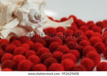 Red wool balls for needlework. On a light background