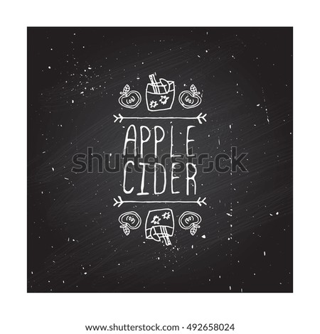 Hand-sketched typographic element with apple, apple cider and text on chalkboard background. Apple cider