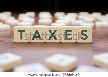 TAXES word on block concept