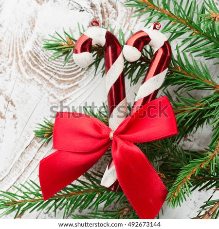 Christmas decorations Candy canes and Fir branches on white rustic wooden background. Holiday concept. Top view