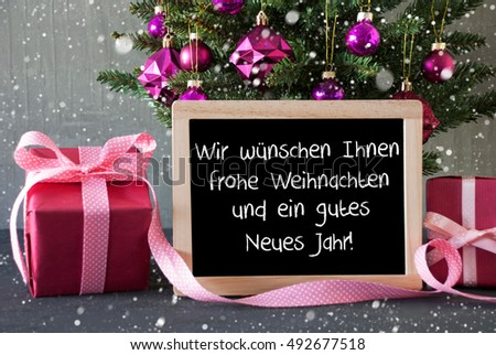 Chalkboard With German Text Wir Wuenschen Ihnen Frohe Weihnachten Und Ein Gutes Neues Jahr Means Merry Christmas And Happy New Year. Christmas Tree With  Balls, Snowflakes And Gifts