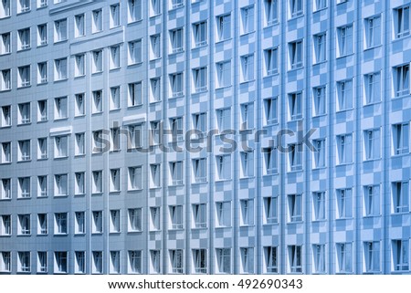 Wall of new residential building with endless row of windows. Black and white photo