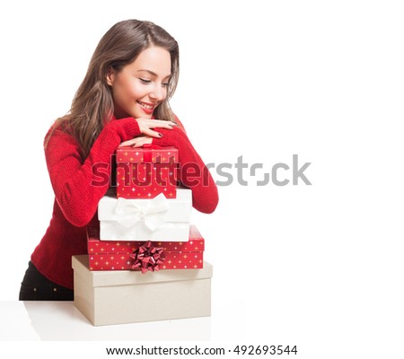 Portrait of a gorgeous young brunette woman holding decorative Christmas gift boxes.