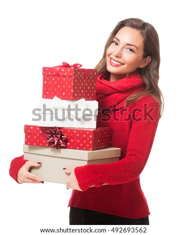 Portrait of a gorgeous young brunette woman holding decorative Christmas gift boxes.