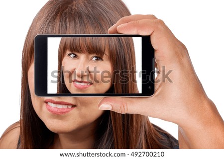 Beautiful brunette woman posing for photo with smartphone isolated