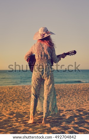 Romantic woman on seashore sunset walk outdoors background. Back view