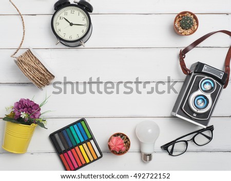 Flat lay clock, glasses,camera,cactus,rope, pencil with wood white background