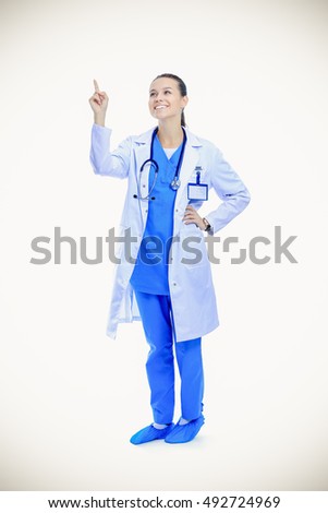 A portrait of a female doctor pointing isolated on white background