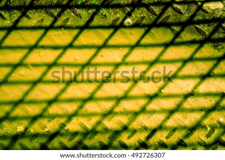grid shadow on ivory brown background, shadow from netting against yellow, netting shadow as texture, high quality resolution