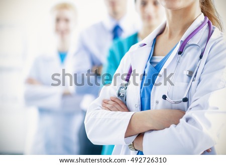 Attractive female doctor in front of medical group Royalty-Free Stock Photo #492726310