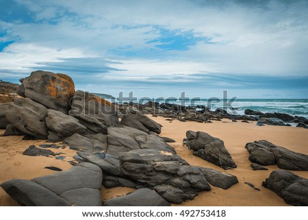 Fishing at Rocky beach storm Australian coast line landscape