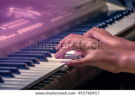 Musician playing piano with vintage filter.