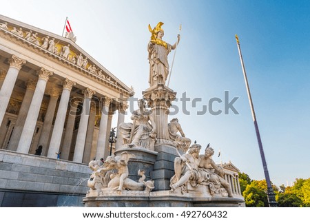 Austrian parliament building with Athena statue on the front in Vienna, Austria. Beautiful travel picture with sunset light.