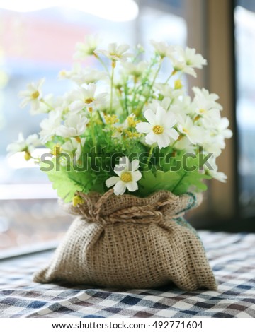 Beautiful artificial flowers made from cloth sitting near window,Home decor concept.