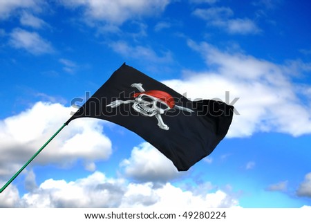 Pirate Jolly Roger Flag in the Blue Cloudy Sky