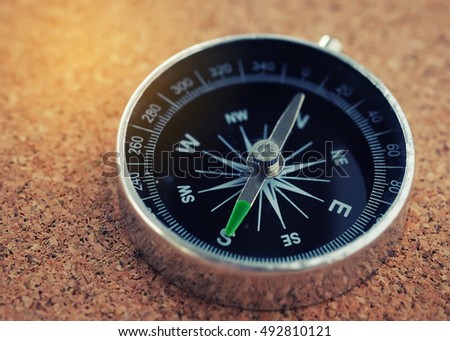 Close up silver Compass on wood background,with copy space - Vintage Filter.