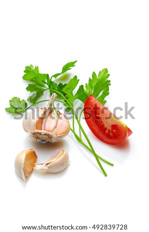 Italian food & drink healthy lifestyle concept: Aromatic Mediterranean vegetable,  herbs & spices. Parsley, tomato & garlic. Top view. Isolated on white. Sharpness across the shot